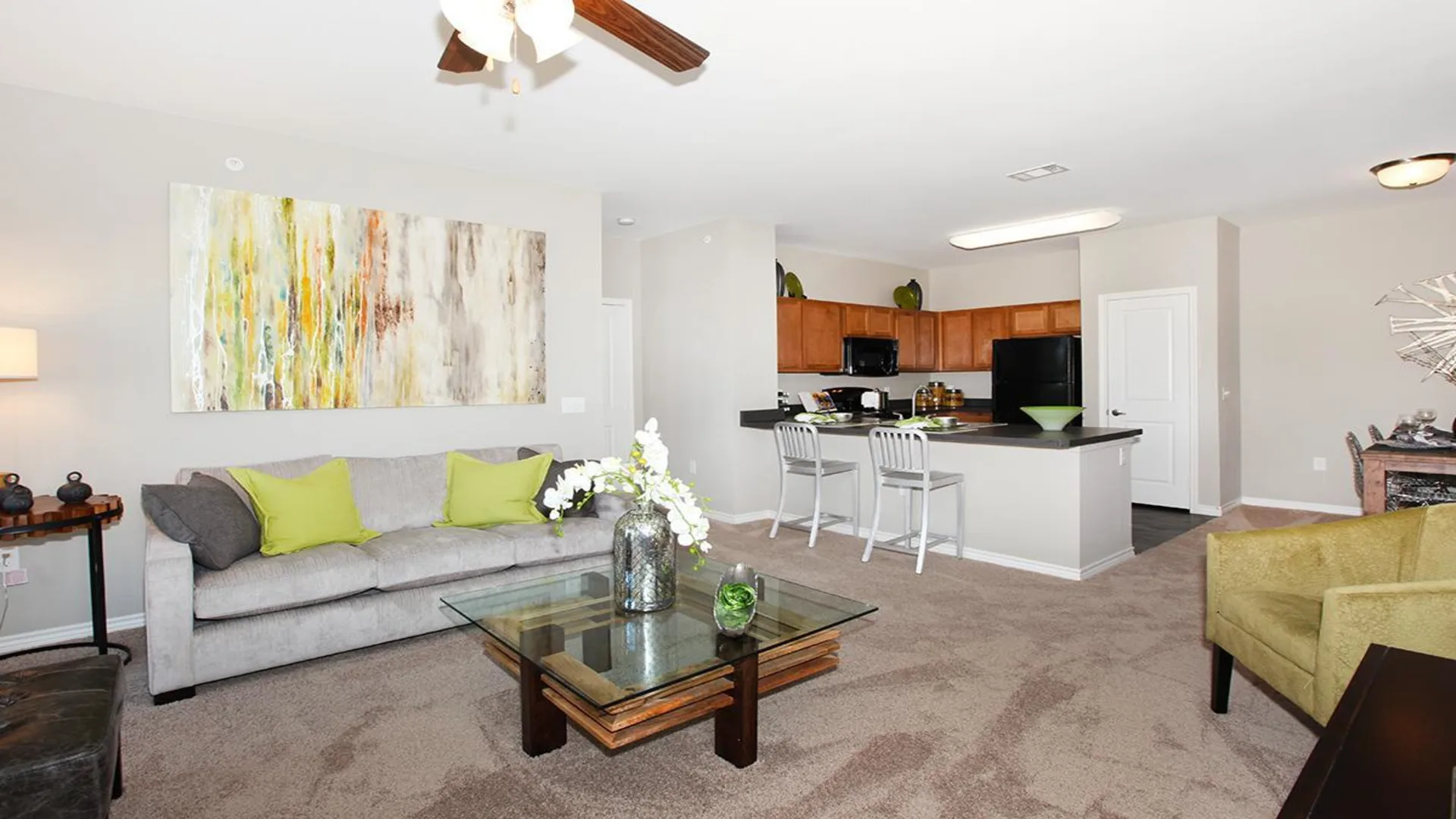 a living room with a couch, coffee table and television at The Outlook Ridge Apartments