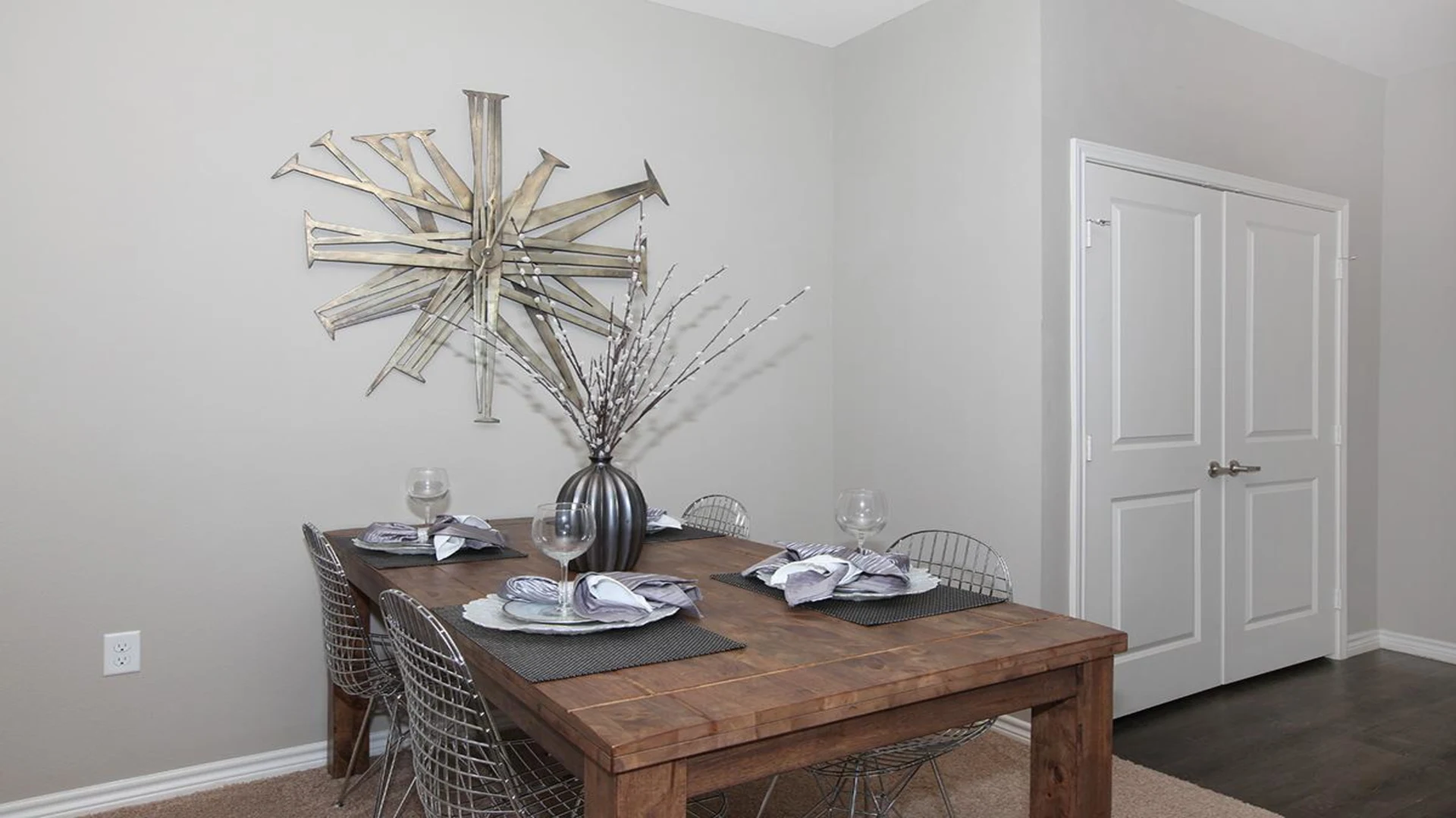 a dining room table with chairs and a large wall art at The Outlook Ridge Apartments