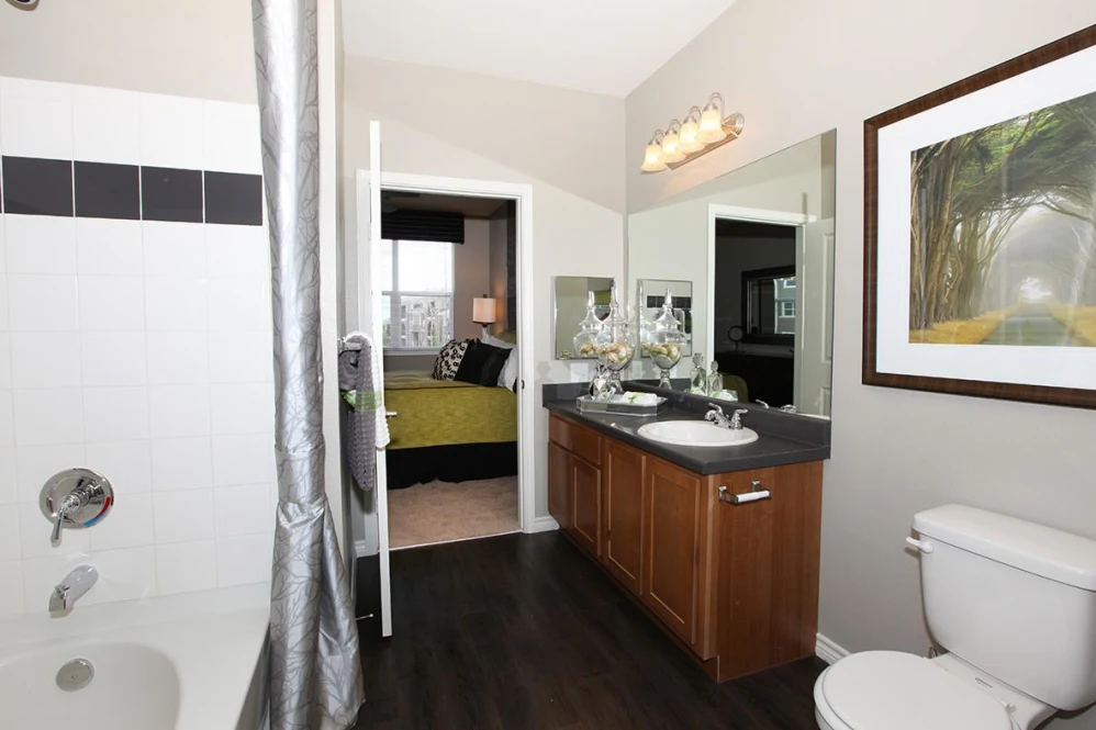 a bathroom with a toilet, sink and shower at The Outlook Ridge Apartments
