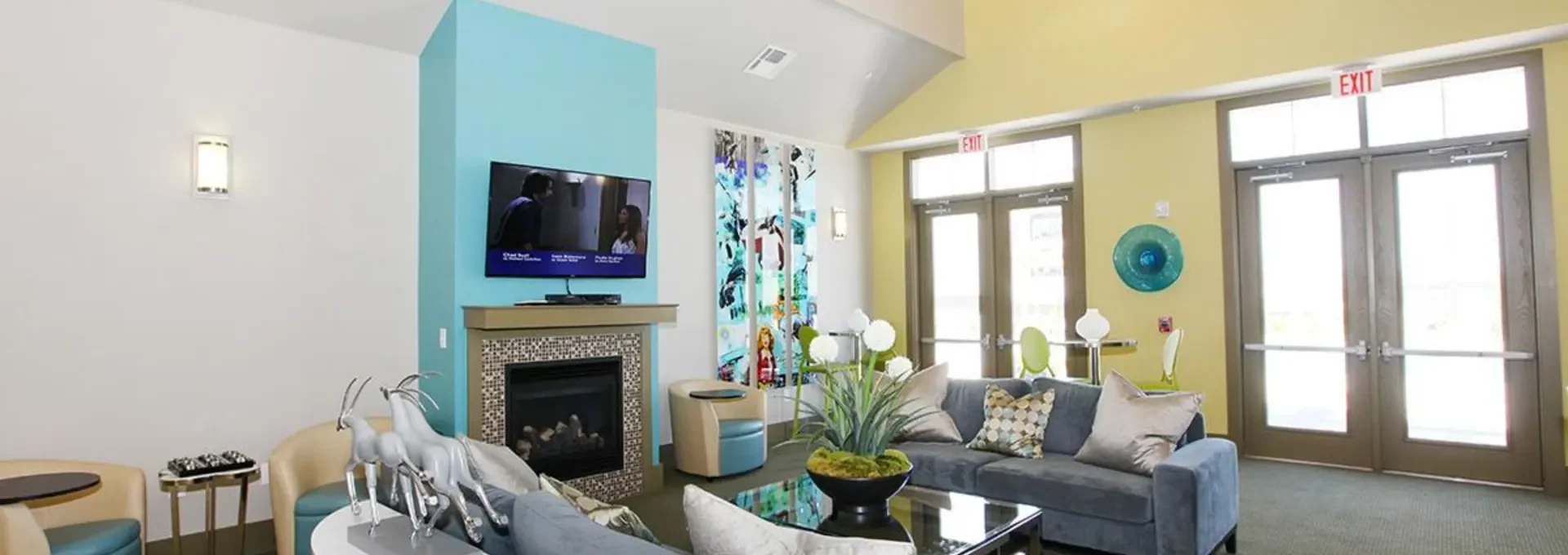 a living room with blue walls and a fireplace at The Outlook Ridge Apartments