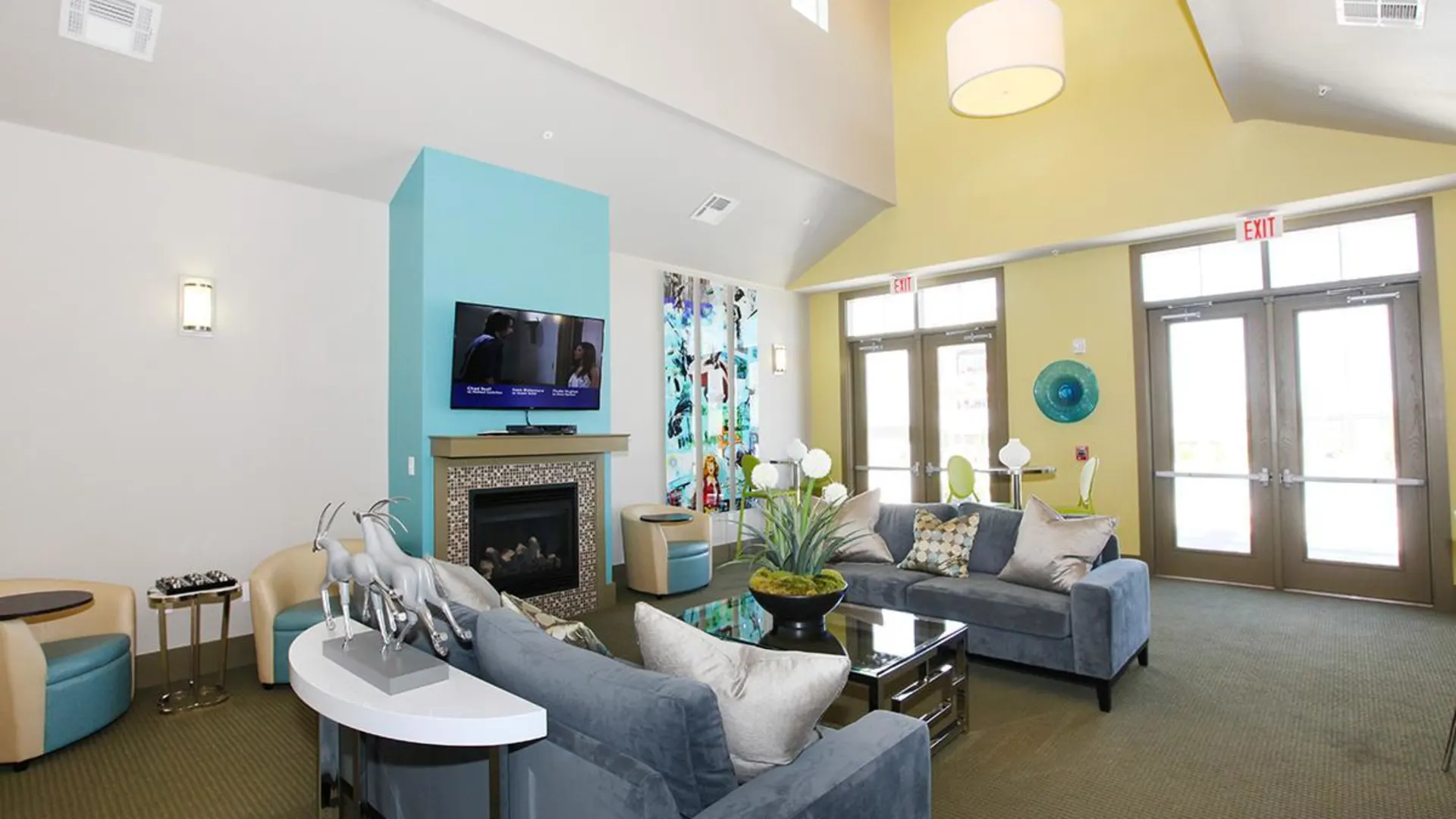 a living room with blue walls and a fireplace at The Outlook Ridge Apartments