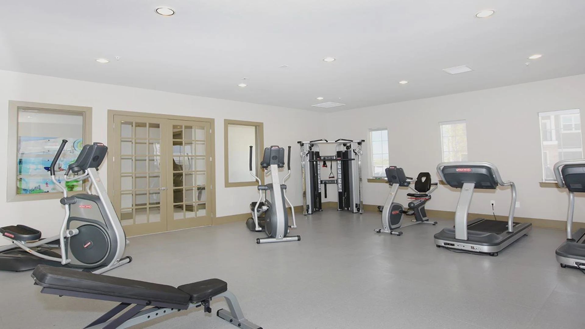 a gym room with exercise equipment and treads at The Outlook Ridge Apartments
