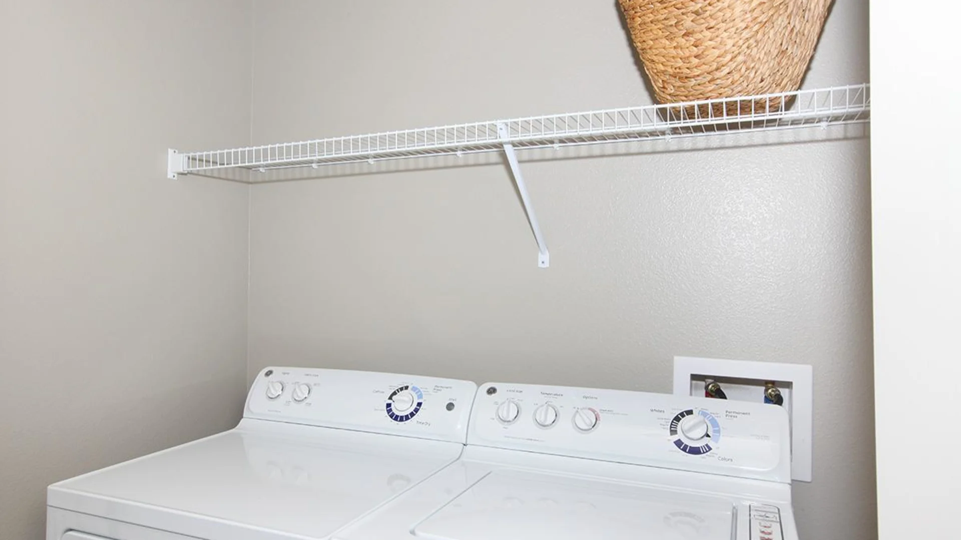 a washer and dryer in a small laundry room at The Outlook Ridge Apartments