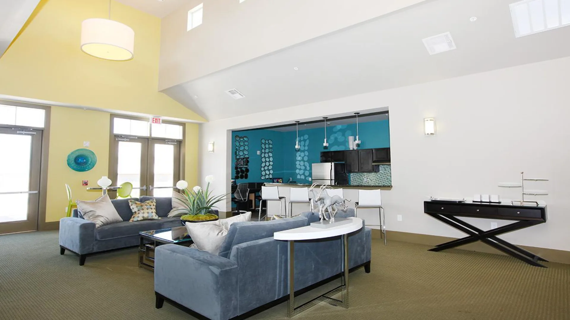 a large open living room with blue walls and yellow accents at The Outlook Ridge Apartments