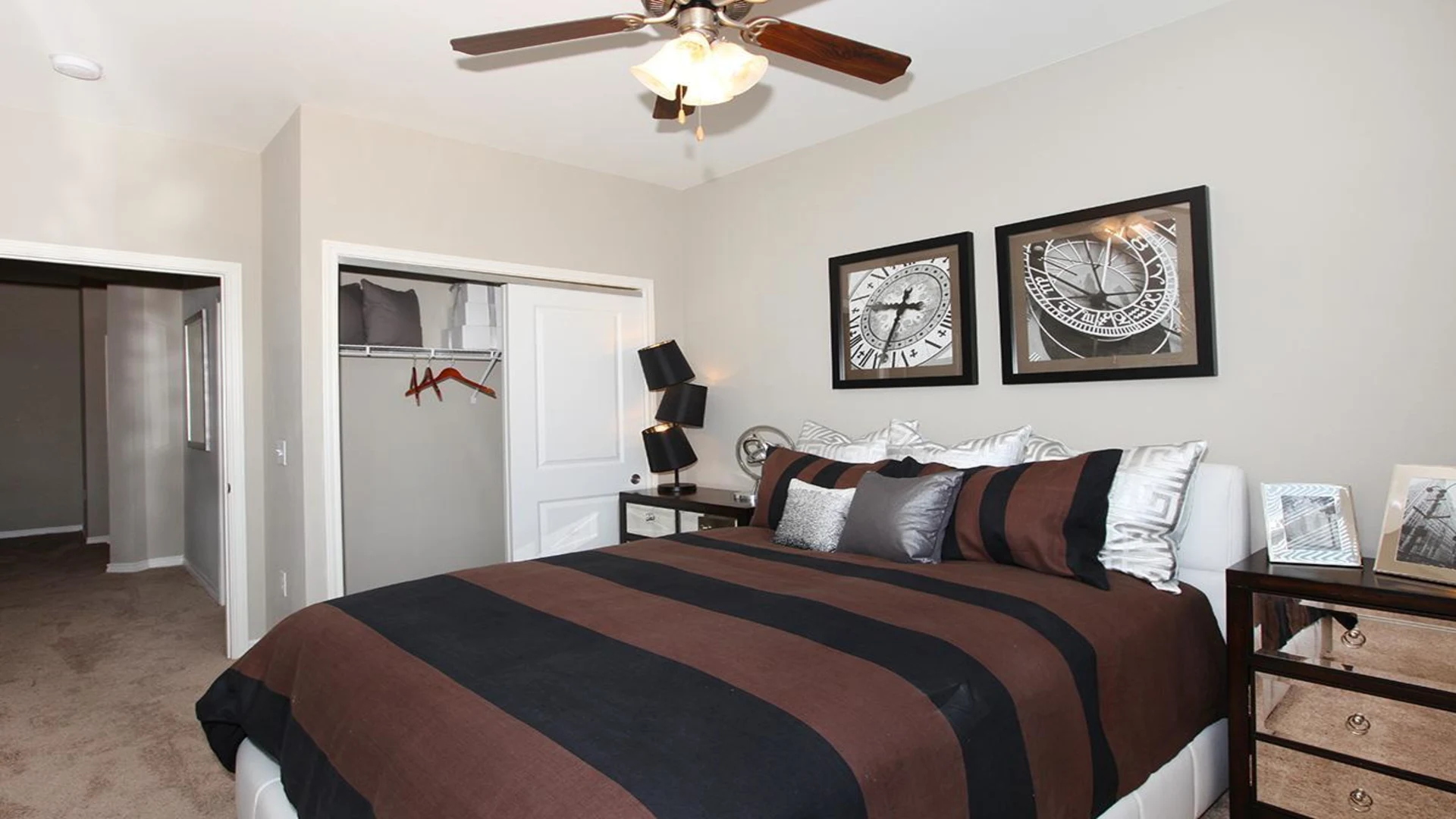 a bedroom with a black and white striped bedspread at The Outlook Ridge Apartments