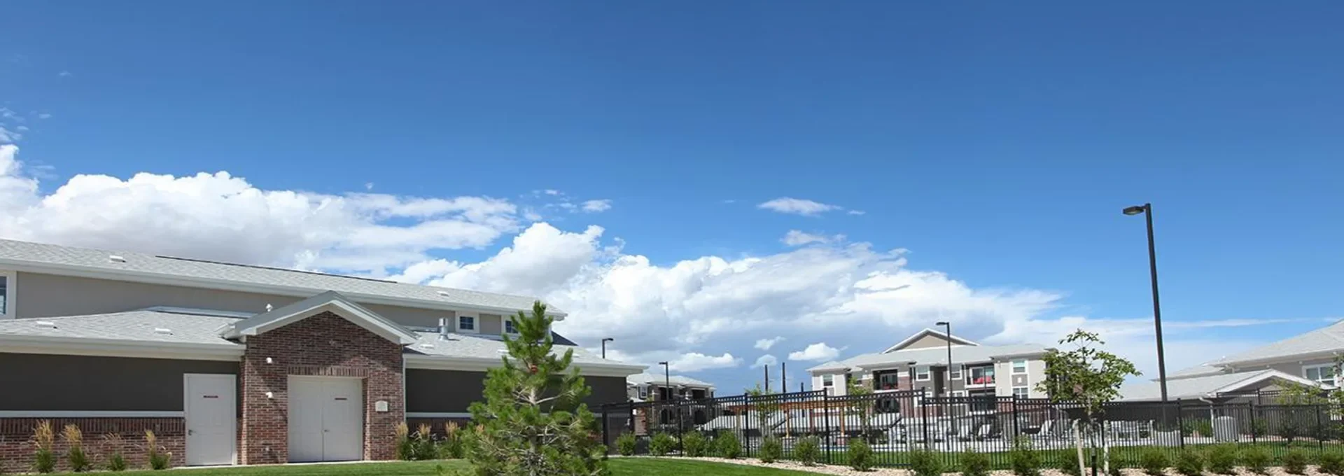 a rendering of a school building with grass and trees at The Outlook Ridge Apartments