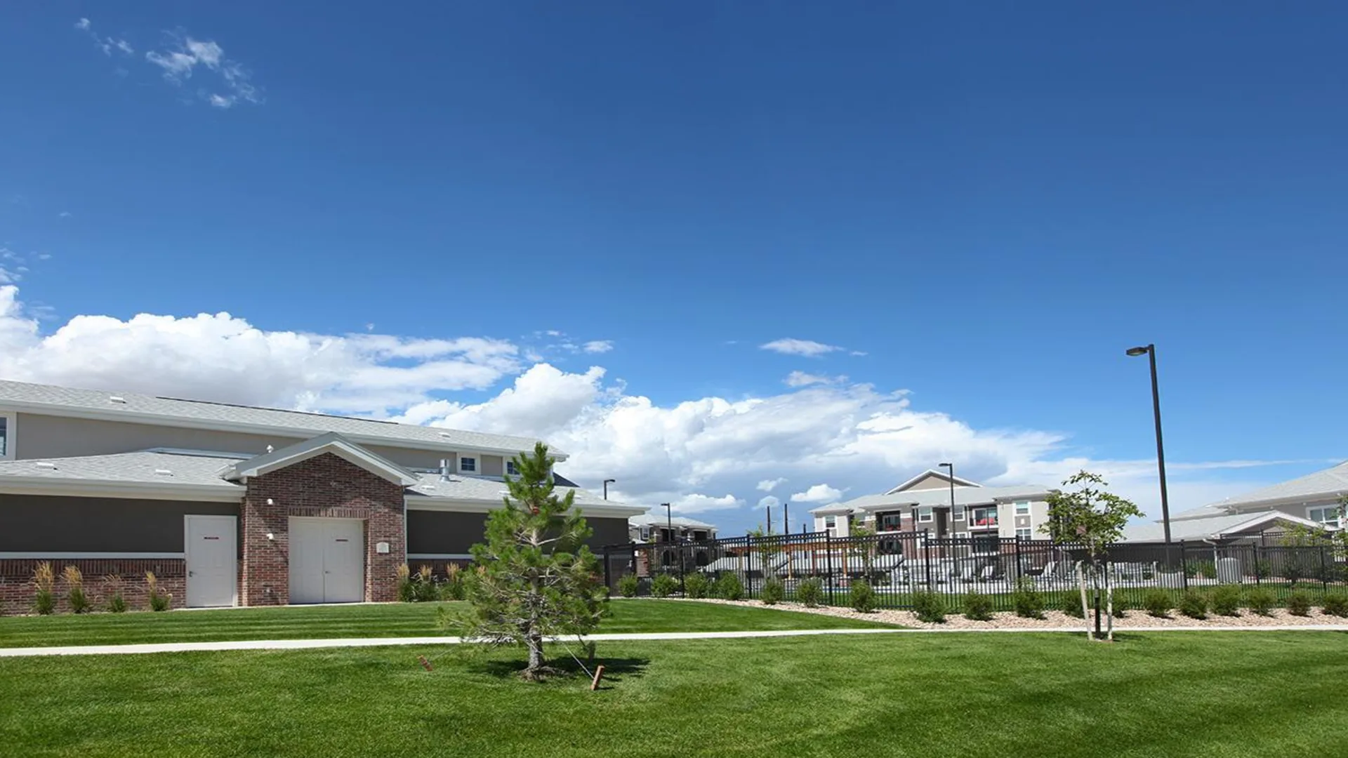 a rendering of a school building with grass and trees at The Outlook Ridge Apartments