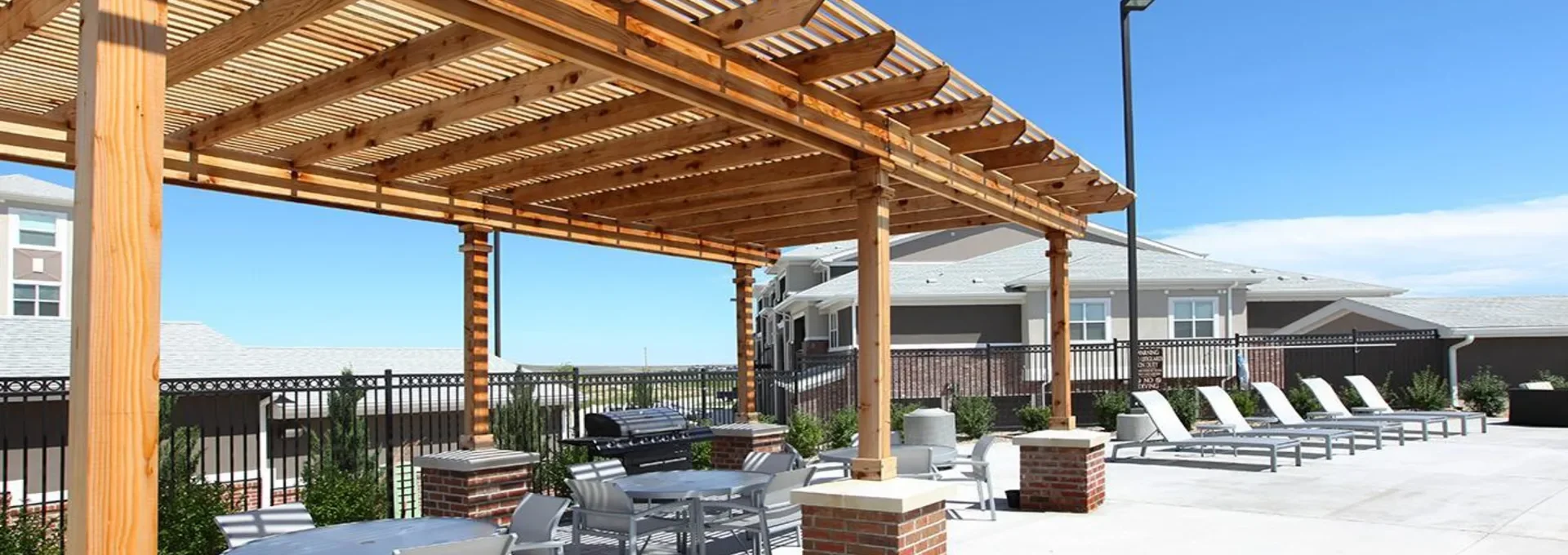 patio with tables and chairs at The Outlook Ridge Apartments